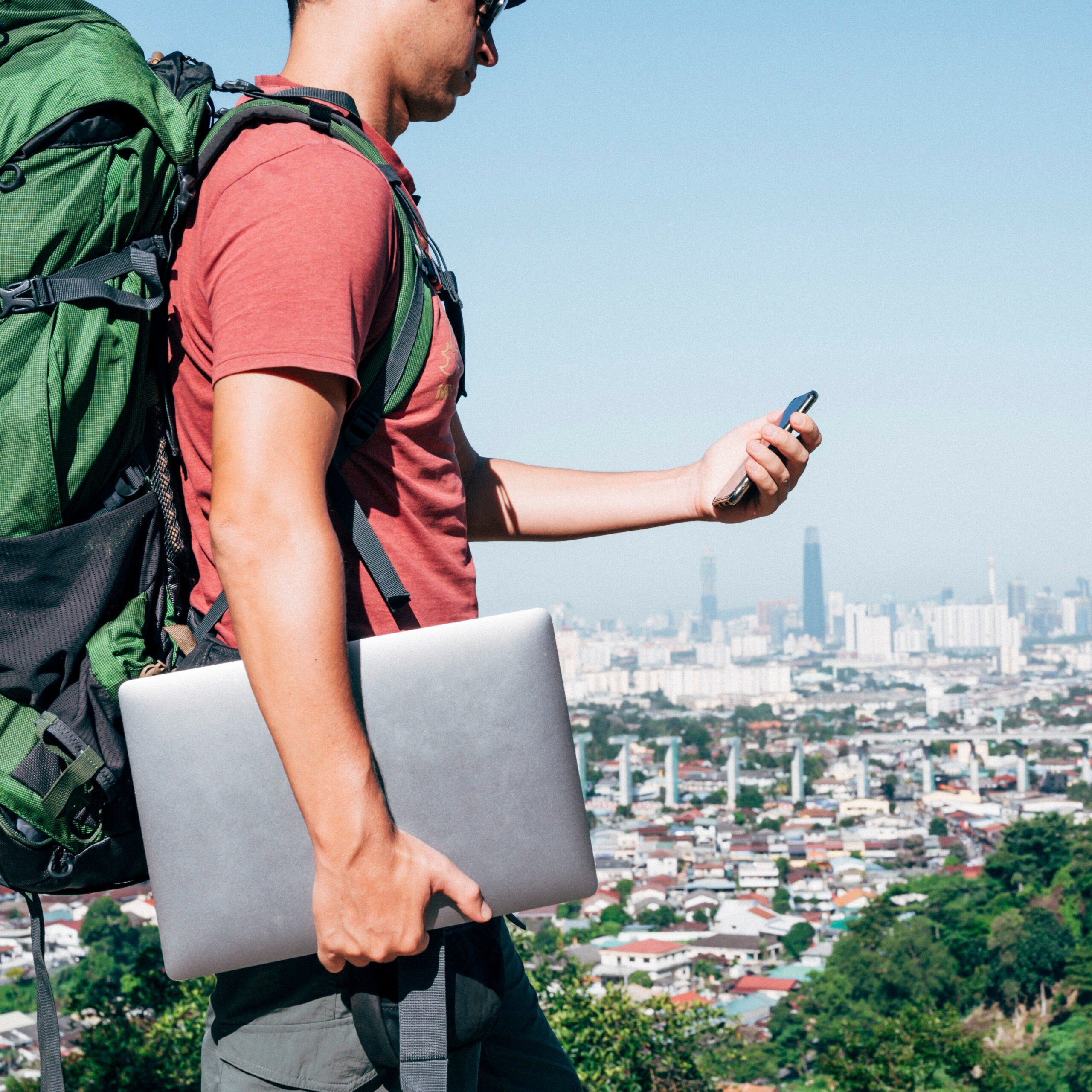 Digital nomad man traveling the world working with smartphone